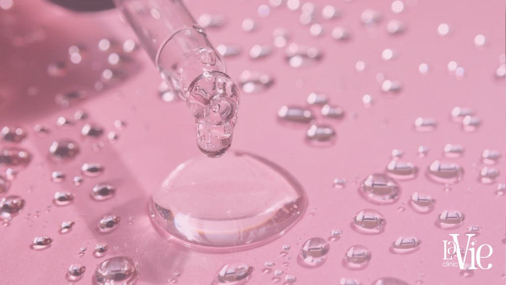 a dropper dripping liquid hyaluronic acid facelift into a dropper